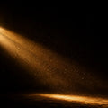 A single beam of light cuts through a dark room, illuminating dust particles — one stream of attention cutting through noise.
